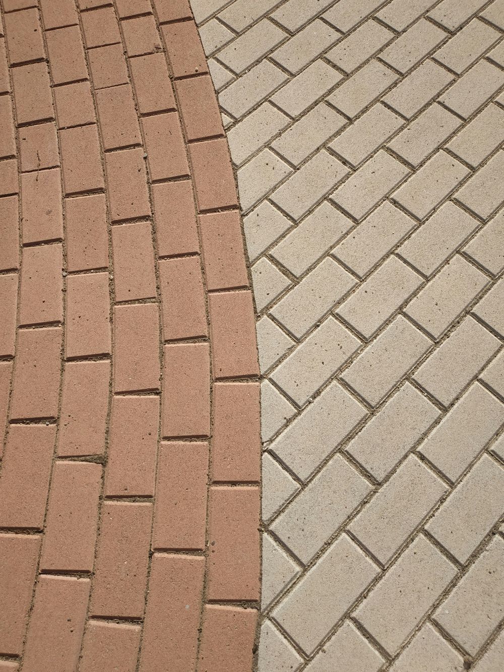 Herringbone paver patio with a curved brick border